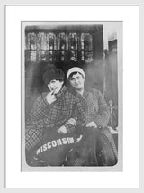 Black and white antique photograph of smiling Wisconsin women in plaid coats.