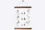 Old-style ABC alphabet chart, black illustrations on white canvas with walnut rods, 35x44.