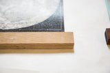 Smooth handmade walnut wood rod securing the black and white moon chart.
