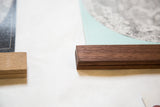 Rich walnut wood rod securing the textured canvas Moon Chart.