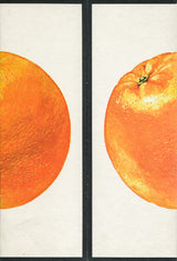 Vibrant orange fruit halves with textured peel and black divider.