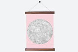 A vintage-style moon chart on pink canvas, complete with its walnut hanging rods.
