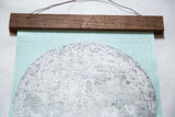 Textured mint canvas and intricate moon detail with walnut wood hanging rod.