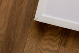 A small chip revealing the wood on a corner of the white frame.