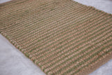 Olive New Carpet's natural jute and olive green handwoven striped texture.