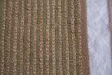 Natural jute texture in olive green and brown checkered pattern with woven border.