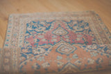 Rug Appraisal service for a vintage floral rug with blue and rose tones, partially rolled.