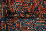Intricate tribal patterns with earthy reds, teal blue, and visible wool knots.