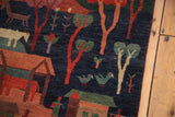 Pictorial imagery of colorful birds, trees, and village homes on a dark indigo Tibetan carpet.