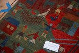 Hand-knotted Tibetan pictorial rug detail: plush green, red, blue human figures.