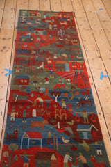 Plush hand-knotted folk art runner depicting herding and farming scenes in indigo and madder.