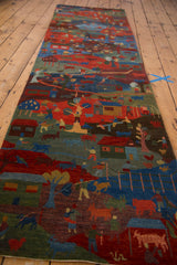 Pictorial folk art runner detail showing herding and village life scenes in indigo and madder.
