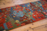 Plush pile detail of a hand-knotted Tibetan folk art runner with pictorial scene.
