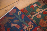 Hand-knotted Tibetan folk art rugs, showing pictorial village scenes in indigo and madder red.