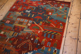 Plush pile Tibetan folk art rug with pictorial village life in rich, natural dyes.