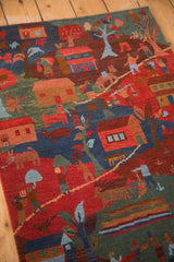 Hand-knotted Tibetan folk art rug displaying rich pictorial scenes of houses, people, and animals.