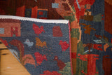 Folded New Tibetan Folk Art rug with pictorial animal motifs in indigo and madder red.
