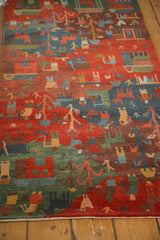 Madder red, indigo blue, and moss green folk art motifs with subtle carved plush pile.