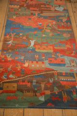 Folk art rug corner, plush pile with carved details in indigo, madder, olive, and brown.