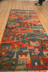 Tibetan folk art runner detail: people, houses, animals in madder red, indigo blue.