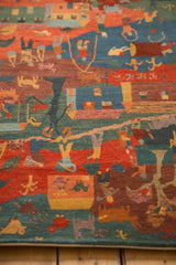 Close-up of plush wool folk art rug with madder red, indigo, and teal colors.