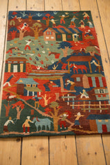 Hand-knotted Tibetan folk art scene of figures, houses, trees; indigo, madder red, green, subtle carving.