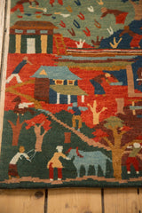 Hand knotted Tibetan folk art rug with villagers, houses, trees, plush pile, and carved texture.