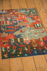 Plush pile and colorful folk art figures on the corner of a Tibetan rug.