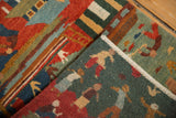 Folded edge of a hand-knotted Tibetan Folk Art rug, showing plush wool pile with stylized figures and geometric patterns.