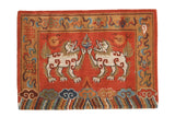 Vibrant madder red hand-knotted Tibetan Fu Dog rug with tangerine and indigo details.