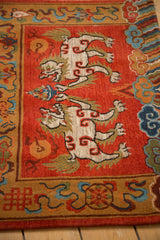 Hand-knotted Tibetan Fu Dog rug with plush madder red pile and carved ivory details.