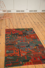 Hand-knotted Tibetan folk art rug with plush pile showing madder red and indigo figures.