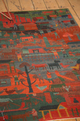 Hand-knotted folk art rug detail with pictorial animals and people in rich red, blue, and green.