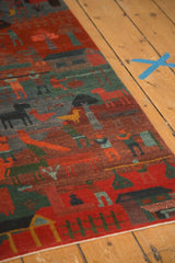 Lower edge of Tibetan folk art rug, madder red field, teal fences, contoured details.