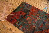 Vibrant red and green Tibetan Folk Art rug with pictorial animal motifs.