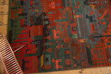 Vibrant madder red, indigo blue, and mallard green folk art pattern on a plush hand-knotted rug.