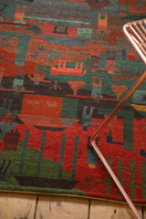Plush, hand-knotted wool pile with abstract madder red and teal green folk art motifs.