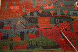 Plush wool pile of Tibetan folk art rug, featuring subtly carved madder red and indigo motifs.