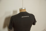 Back of charcoal t-shirt showing the website logo and white contrast stitching.