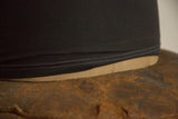 Close-up of the double row of contrast stitching on the charcoal t-shirt hem.