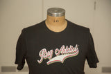 The retro 'Rug Addict' logo with colorful accents on a charcoal contrast stitch t-shirt.