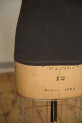 Light contrast stitching along the curved hem of the heathered charcoal t-shirt.