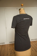 Back of the women's charcoal scoop neck tee with white logo and contrast stitching.