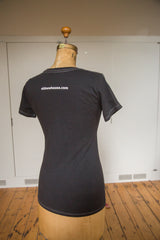 Back of a women's charcoal t-shirt showing white contrast stitching and printed URL.