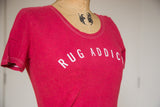 Close-up of the 'Rug Addict' graphic and contrast stitching on the scoop neck t-shirt.