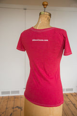 Back of the watermelon red t-shirt with website print and white contrast stitching.