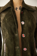 Close-up of the vintage Gucci coat's green suede, pointed collar, and signature enamel buttons.