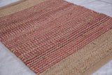 Jute rug with handwoven texture, featuring natural beige and rose-pink stripes.