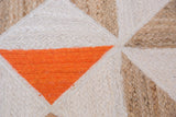 Handmade braided geometric pattern in vivid orange, natural jute, and undyed cotton.