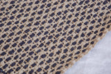 Handmade Rowan jute rug detail showcasing a dark blue and natural beige geometric woven lattice.